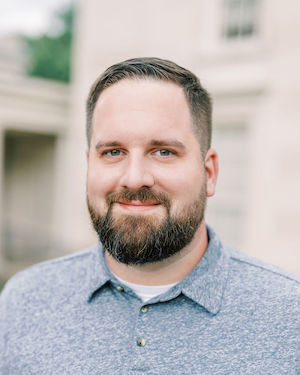 Brandon Landfried sitting on the garden steps outside the VMFA